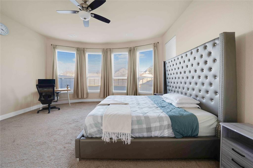 7024 Green Field Street Little Elm, TX 76227 - Photo 9 of 27 a bedroom with a bed and a chandelier