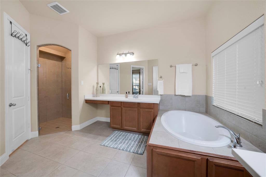 7024 Green Field Street Little Elm, TX 76227 - Photo 10 of 27 a bathroom with a sink and a bathtub