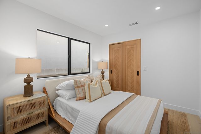 a bedroom with a bed and a window