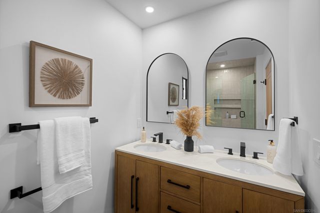 a bathroom with a double vanity sink and a mirror