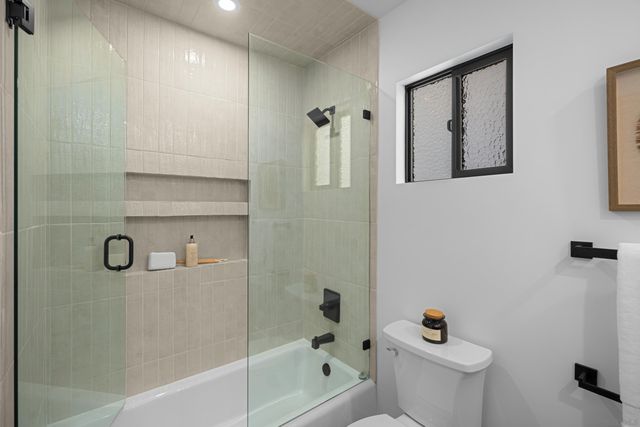 a bathroom with a shower and toilet