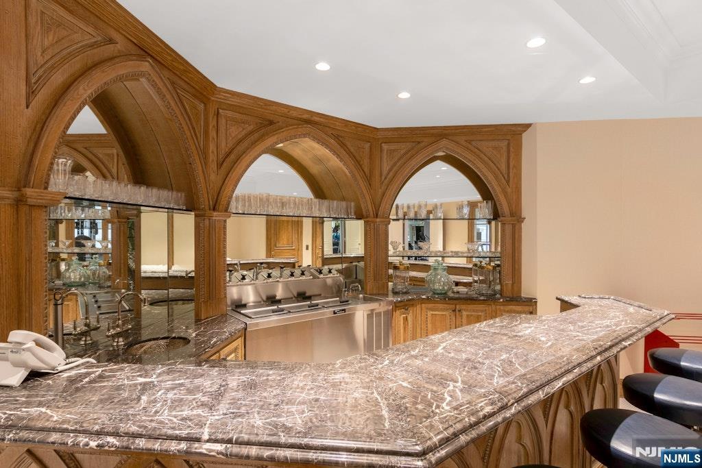 38 Rio Vista Drive Alpine, NJ 07620 - Photo 30 of 39 a view of open kitchen with granite countertop a dining table chairs with a grill and chandelier