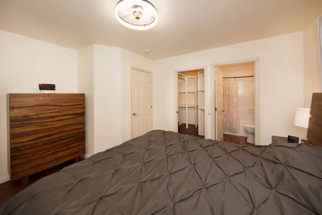 a bedroom with a bed and a chandelier