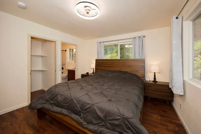 a bedroom with a bed and a window