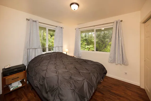 a bed sitting in a bedroom next to a window