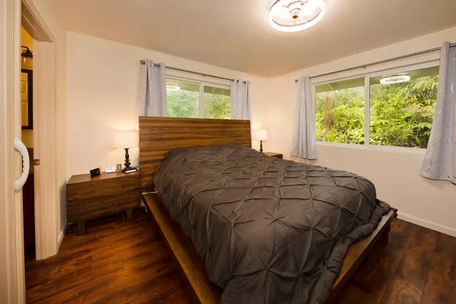 a bed sitting in a bedroom next to a window