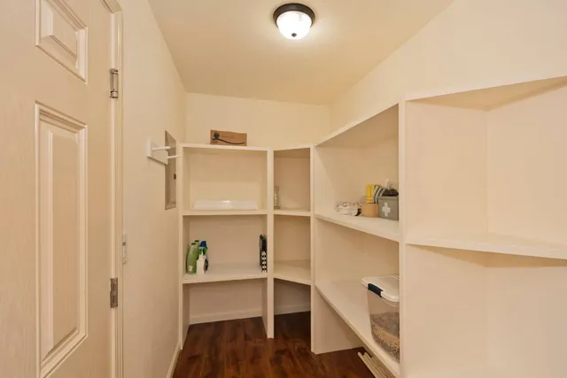 a view of walk in closet with empty racks