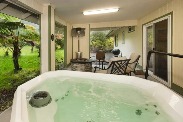 a view of a dining room with furniture and garden view