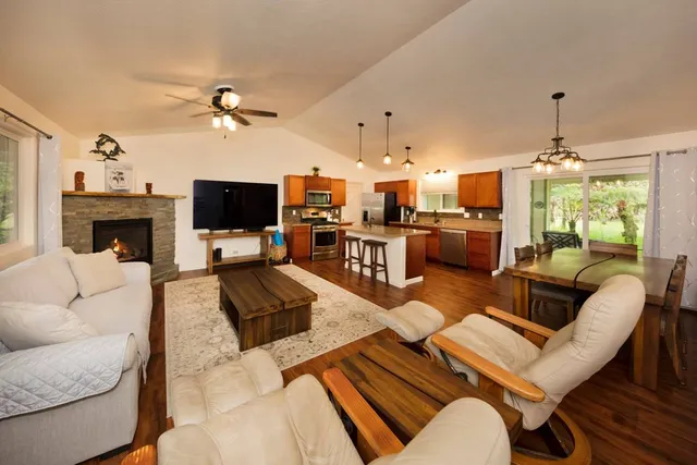 a living room with furniture a fireplace and a flat screen tv