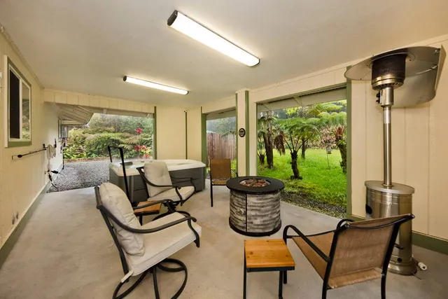 a living room with patio furniture and a large window