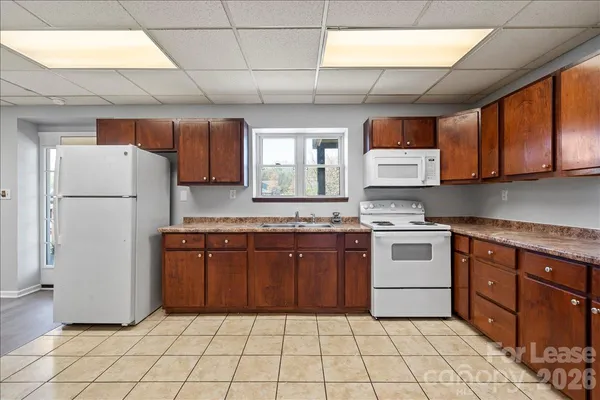 a kitchen with a refrigerator sink and cabinets