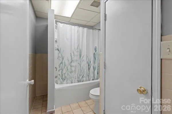 a bathroom with a toilet and shower