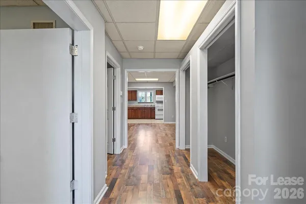 a view of hallway with wooden floor