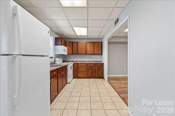 a kitchen with stainless steel appliances a refrigerator sink and cabinets