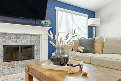 a kitchen with stainless steel appliances granite countertop a refrigerator a stove a sink a dining table and chairs with wooden floor