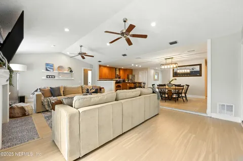 a living room with furniture a flat screen tv and a window