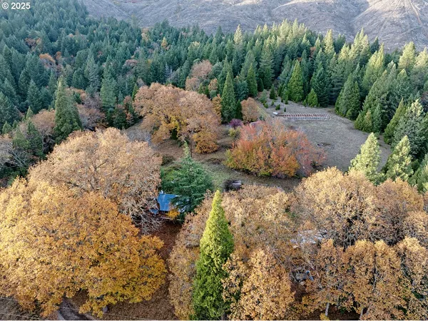 an aerial view of a house with a yard