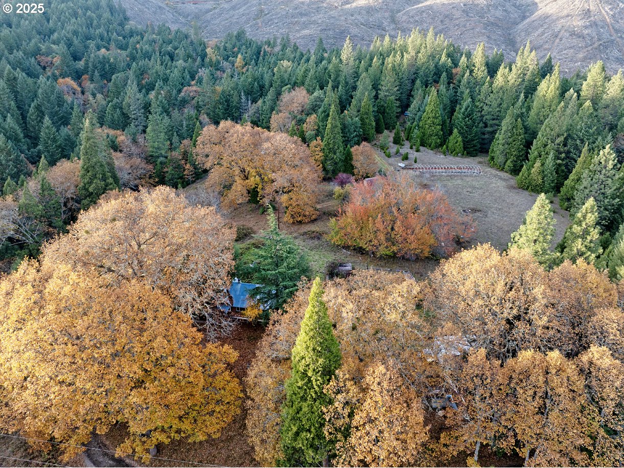 an aerial view of a house with a yard