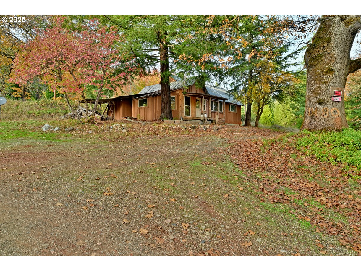 1480 Bridge Lane Wolf Creek, OR 97497 - Photo 14 of 28 a view of a house with a yard