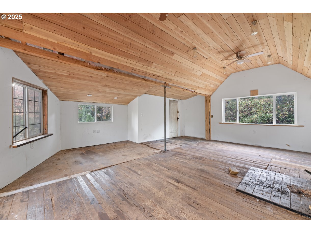 1480 Bridge Lane Wolf Creek, OR 97497 - Photo 24 of 28 a view of an empty room with wooden floor and a window