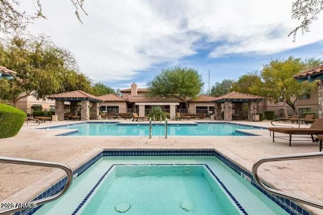 a swimming pool with outdoor seating and yard