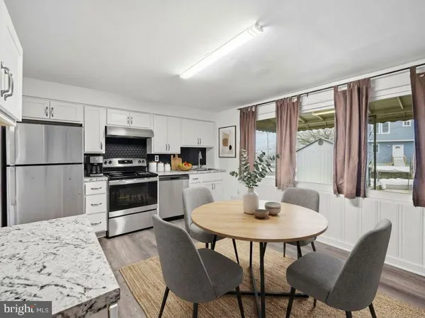 a kitchen with a dining table and chairs