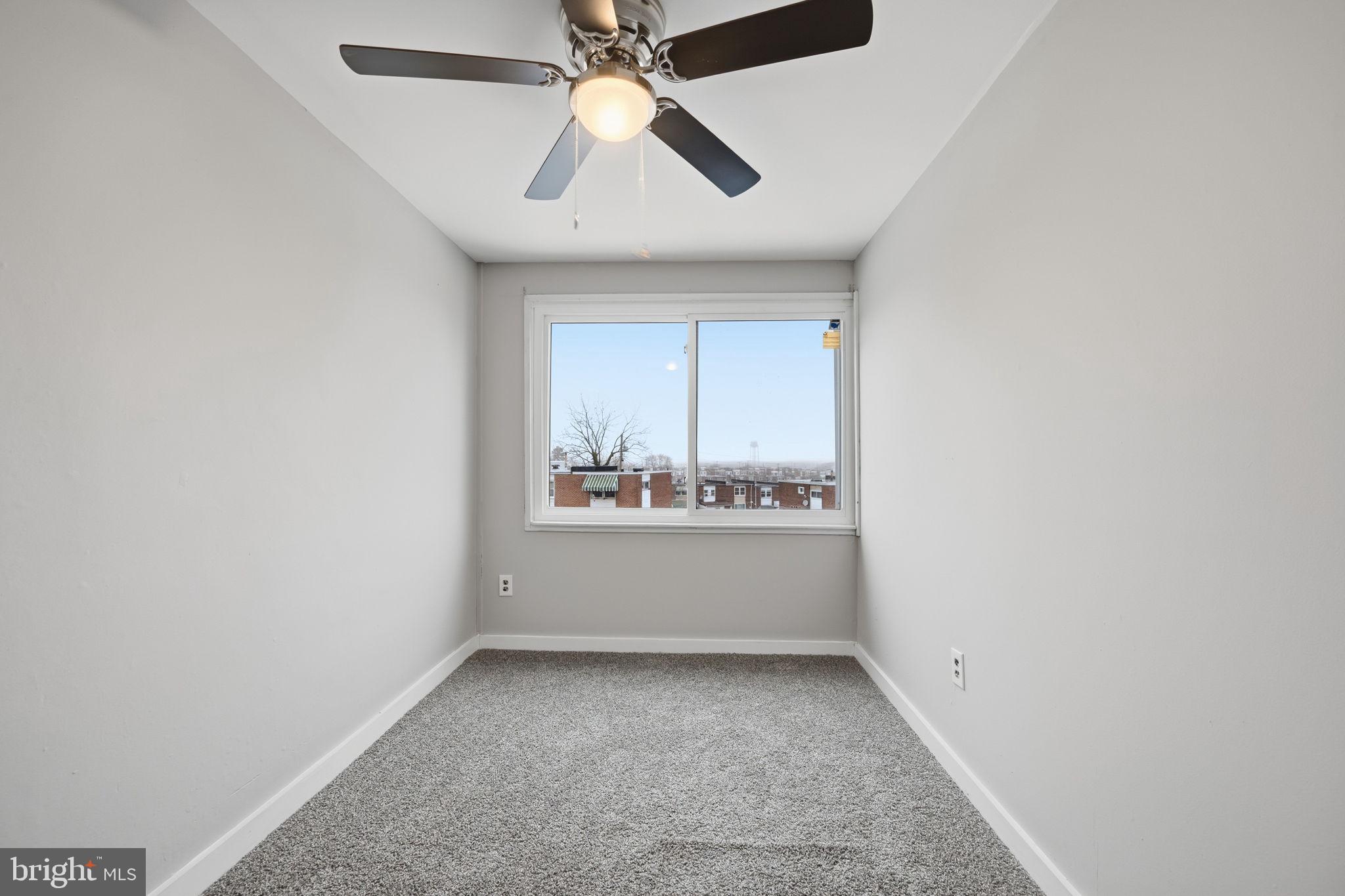 7911 Bank Street Baltimore, MD 21224 - Photo 16 of 40 an empty room with chandelier fan