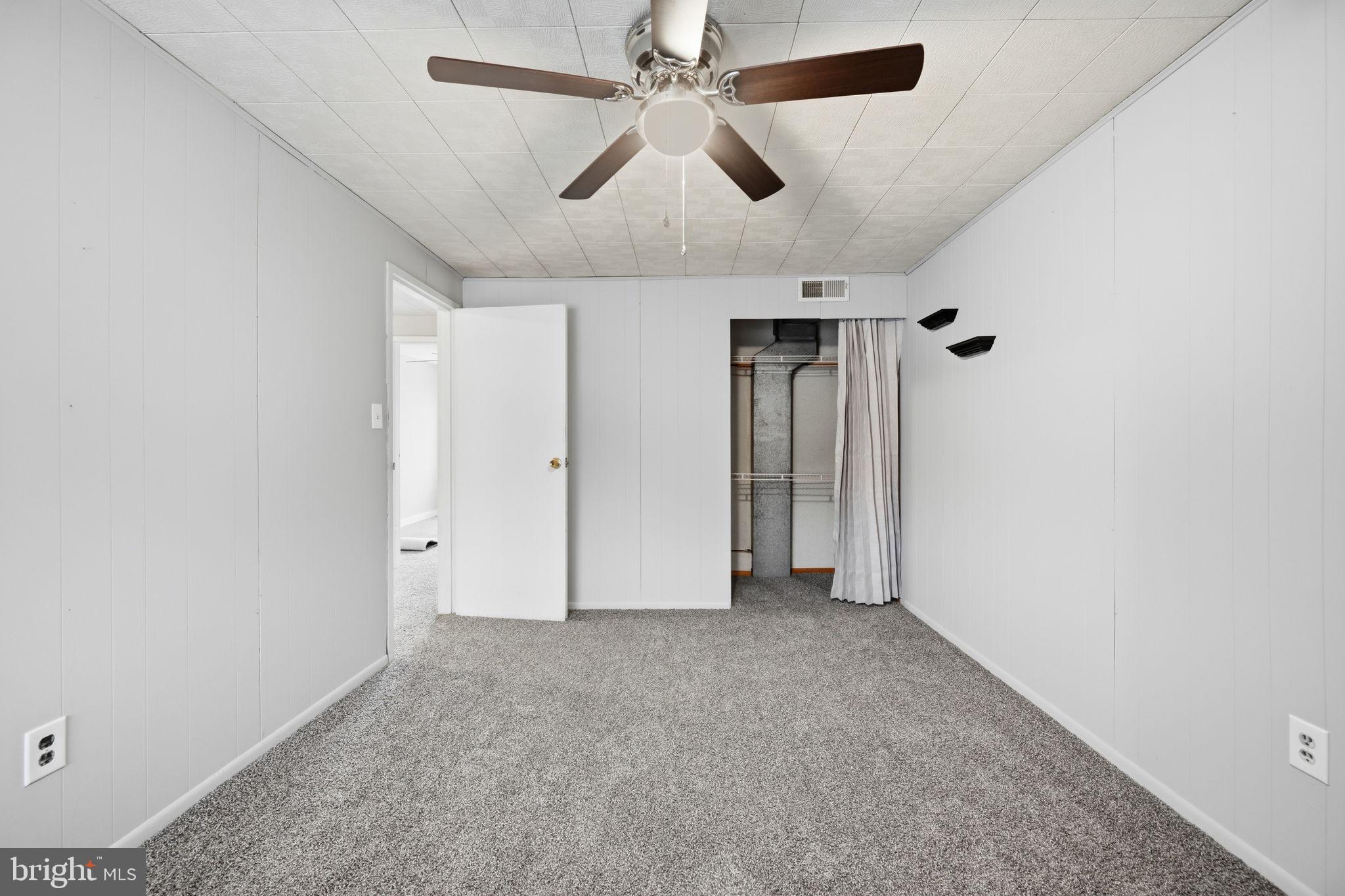 7911 Bank Street Baltimore, MD 21224 - Photo 22 of 40 an empty room with chandelier fan