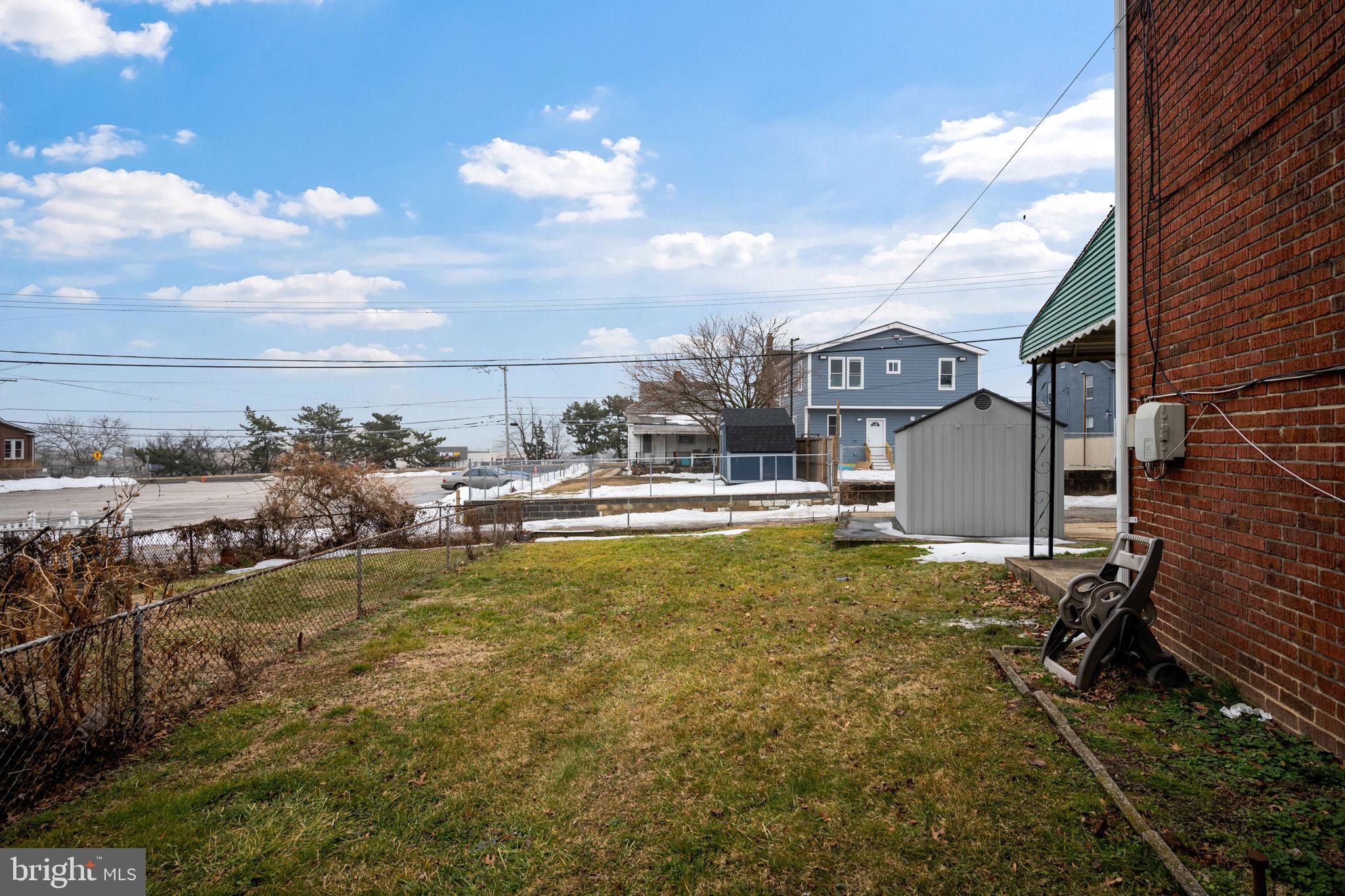 7911 Bank Street Baltimore, MD 21224 - Photo 38 of 40 a swimming pool with outdoor seating and yard