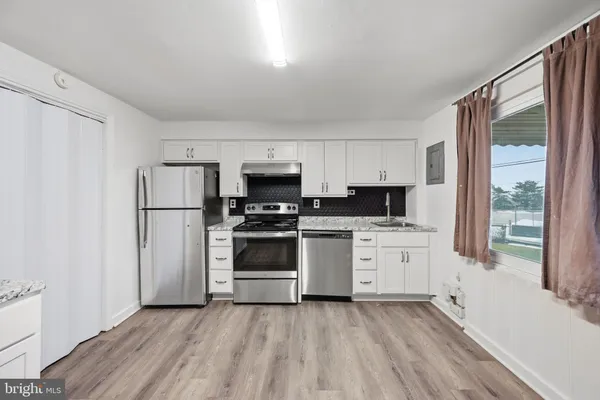 a kitchen with stainless steel appliances a refrigerator sink and microwave