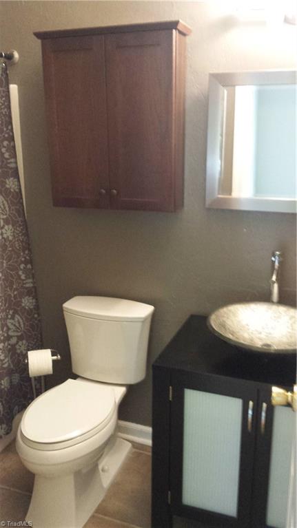 3712 Sutton Way High Point, NC 27265 - Photo 15 of 18 Renovated hall bath with ceramic tile flooring and vanity with glass vessel sink.