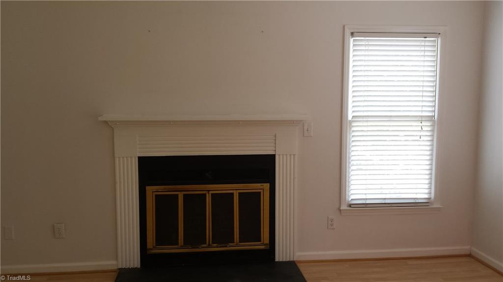 3712 Sutton Way High Point, NC 27265 - Photo 3 of 18 The living room has 2 windows and a Majestic gas log fireplace.