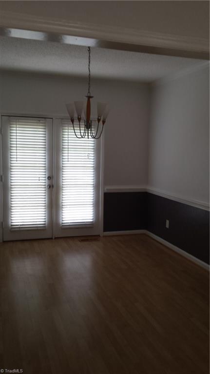 3712 Sutton Way High Point, NC 27265 - Photo 5 of 18 Dining room with laminate flooring, wainscoating and french doors that lead to the deck.