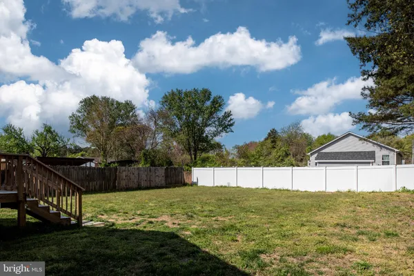 a view of a house with a yard and sitting area