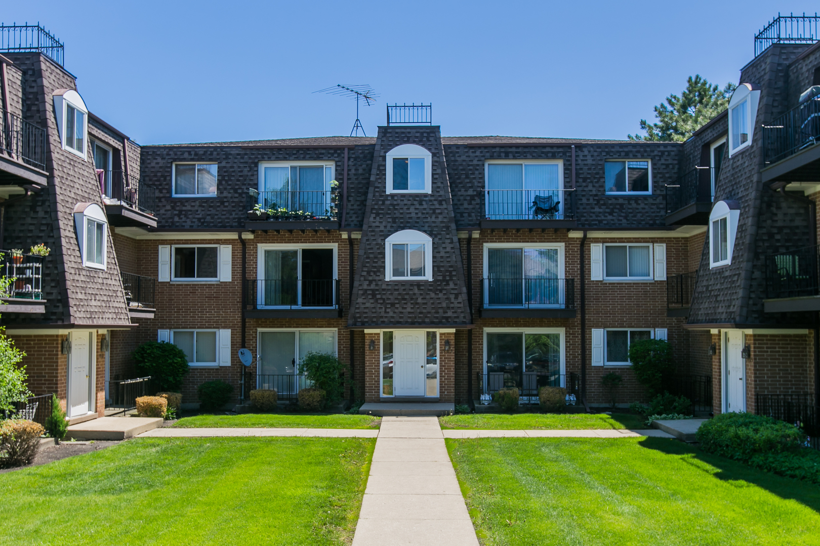 1903 West Golf Road, Unit 2A Mount Prospect, IL 60056 - Photo 1 of 20 a front view of a brick building with a yard