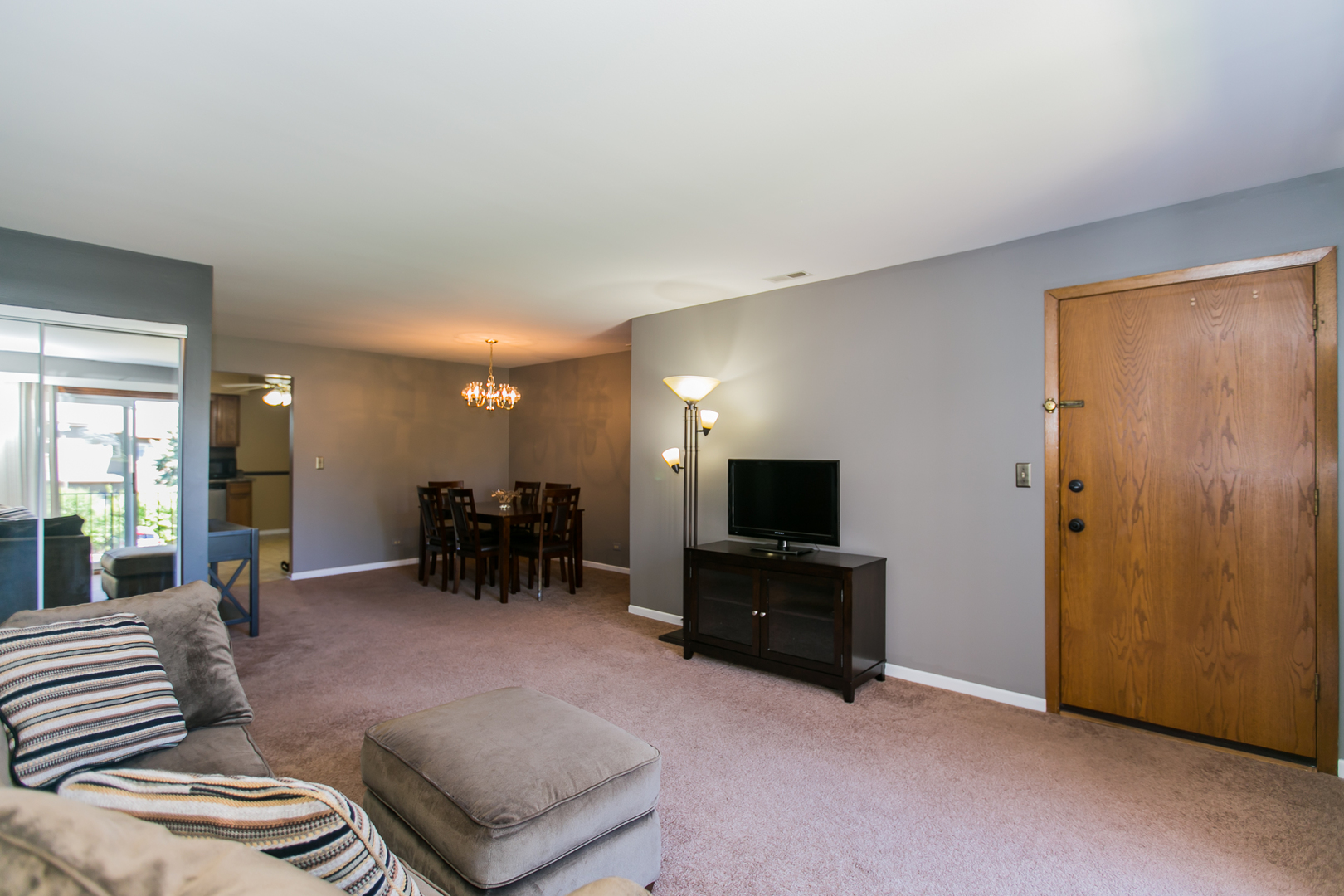 1903 West Golf Road, Unit 2A Mount Prospect, IL 60056 - Photo 2 of 20 a living room with furniture and a flat screen tv