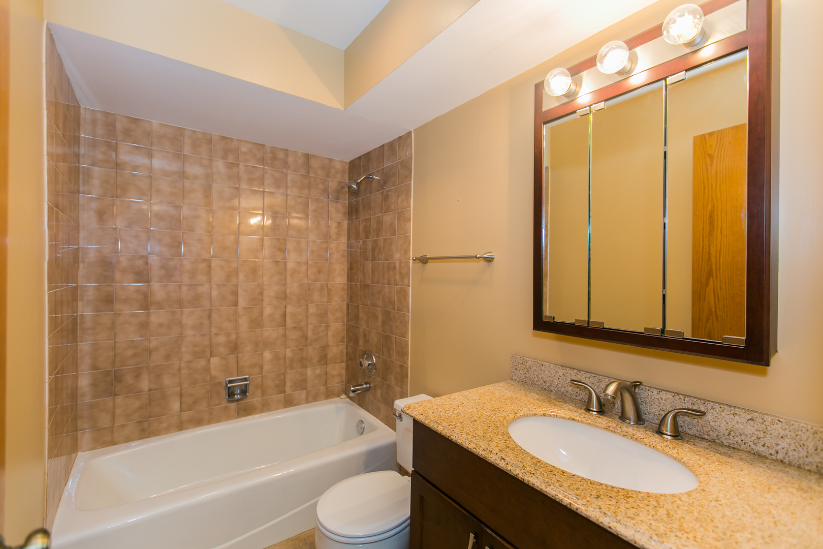 1903 West Golf Road, Unit 2A Mount Prospect, IL 60056 - Photo 17 of 20 a bathroom with a granite countertop sink toilet and shower