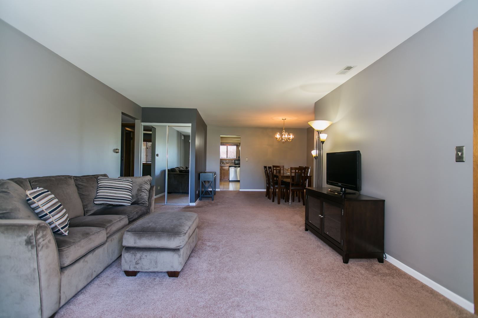 1903 West Golf Road, Unit 2A Mount Prospect, IL 60056 - Photo 5 of 20 a living room with furniture and a flat screen tv