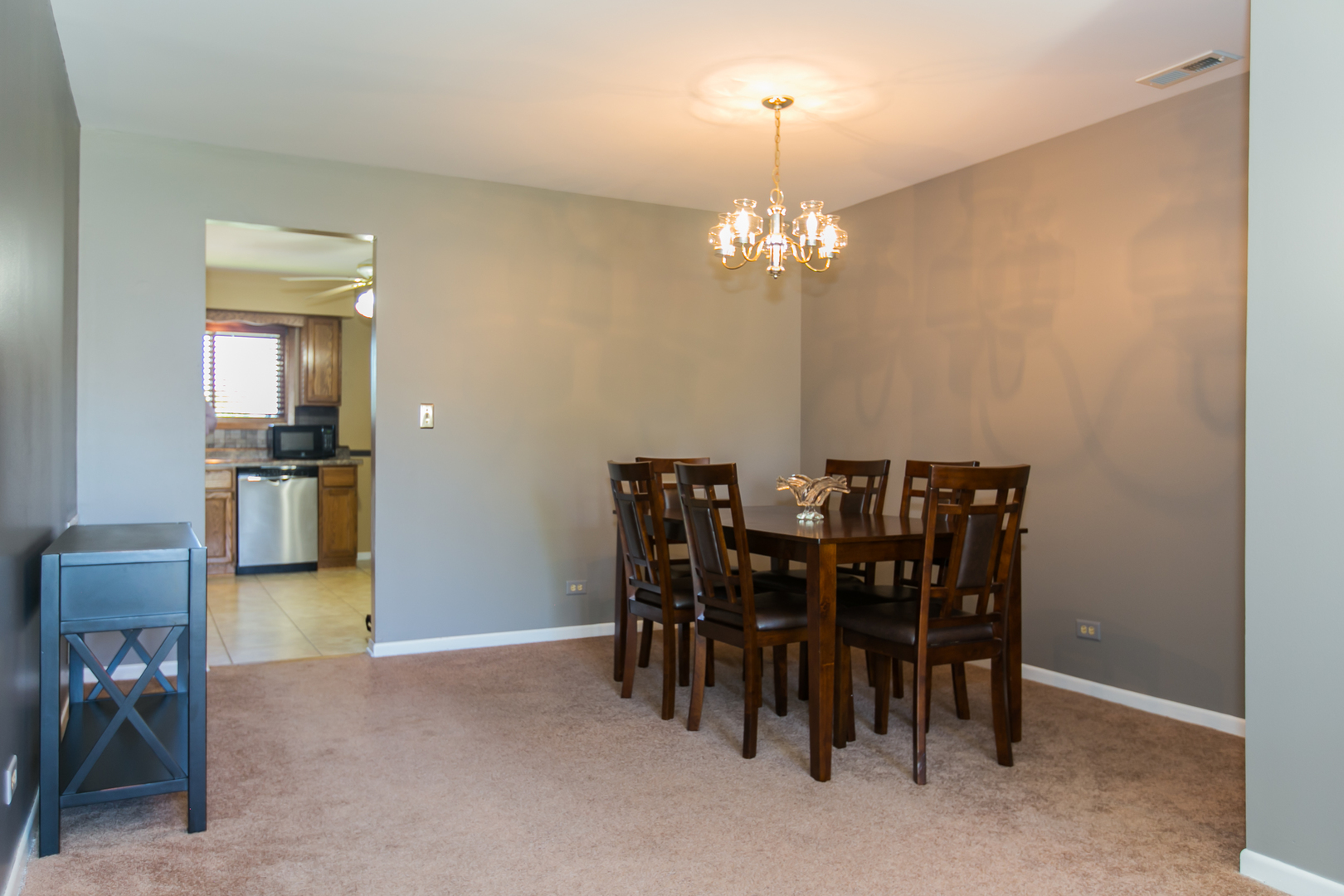 1903 West Golf Road, Unit 2A Mount Prospect, IL 60056 - Photo 7 of 20 a view of a dining room with furniture and chandelier