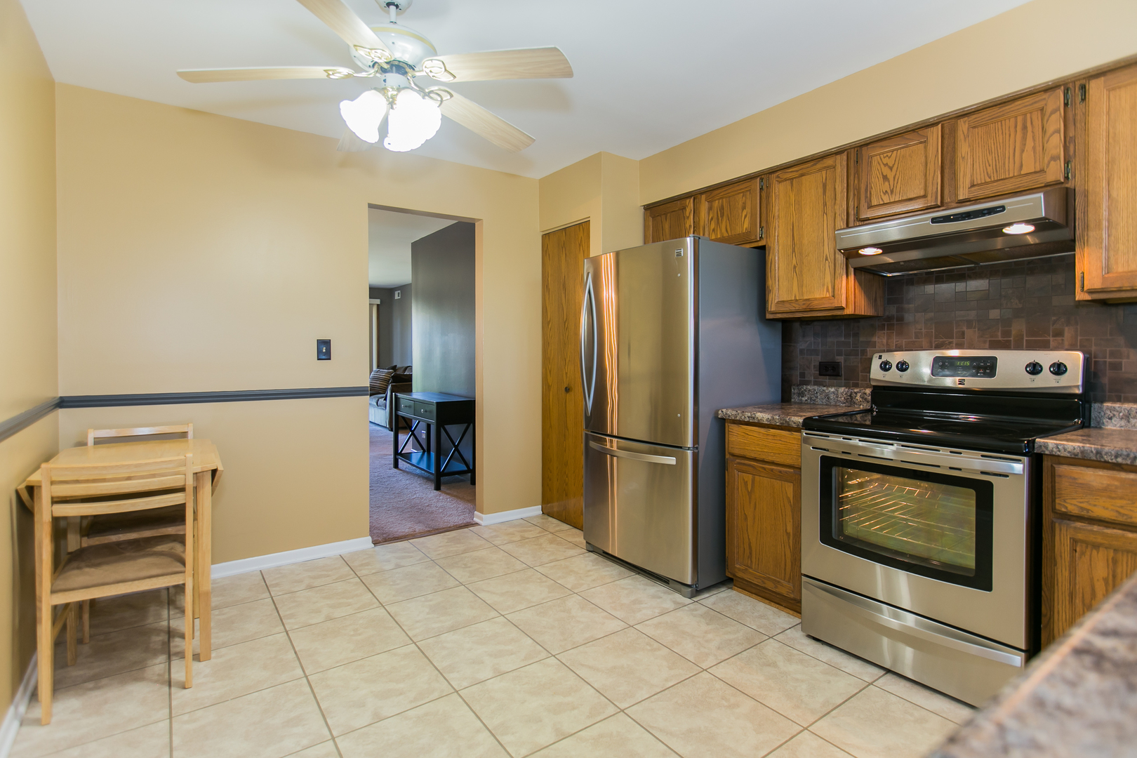 1903 West Golf Road, Unit 2A Mount Prospect, IL 60056 - Photo 9 of 20 a kitchen with stainless steel appliances granite countertop a refrigerator a stove and a sink