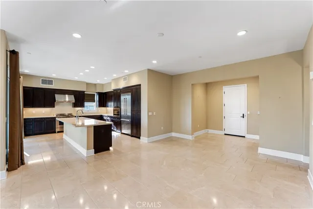 a view of kitchen with stainless steel appliances kitchen island sink refrigerator and stove