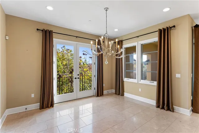 a view of a hallway with a chandelier and livingroom view