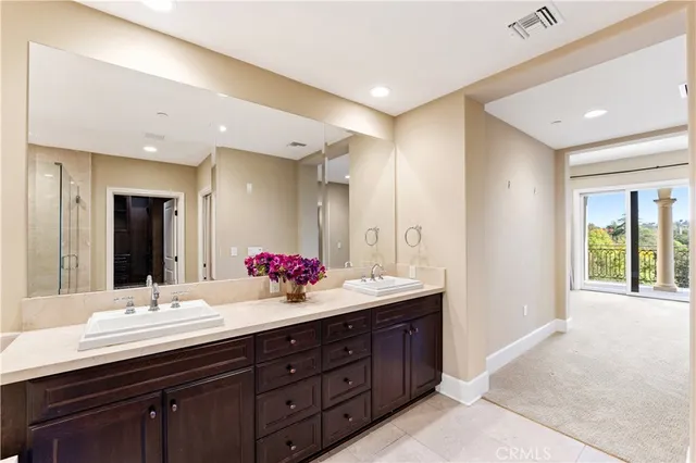 a bathroom with a double vanity sink mirror and shower
