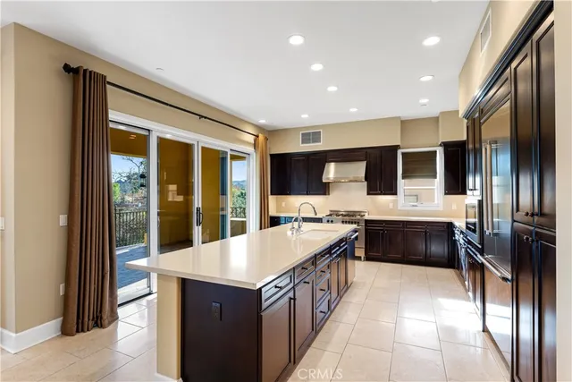 a large kitchen with a large counter top cabinets and stainless steel appliances