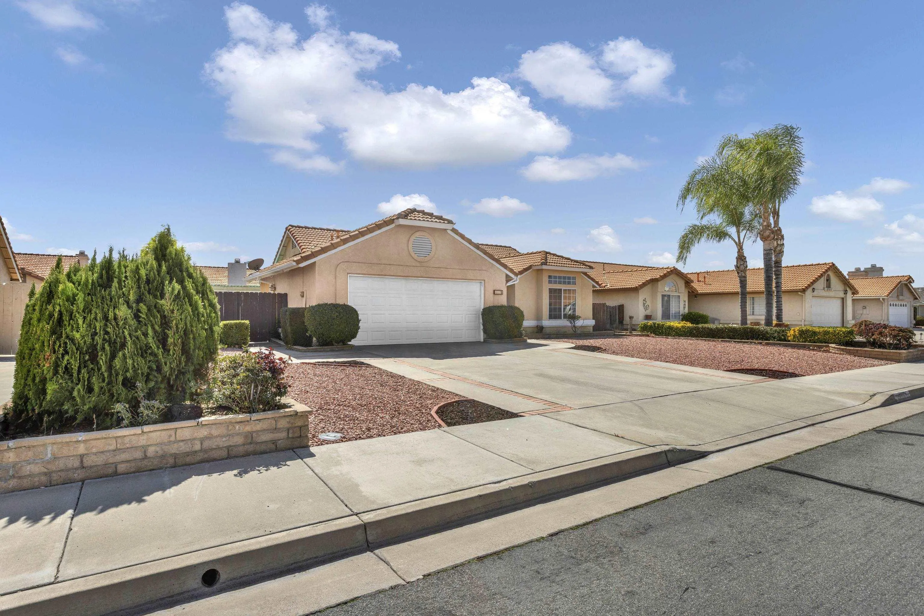 27325 Terrytown Road Menifee, CA 92586 - Photo 3 of 44 a front view of a house with a garden