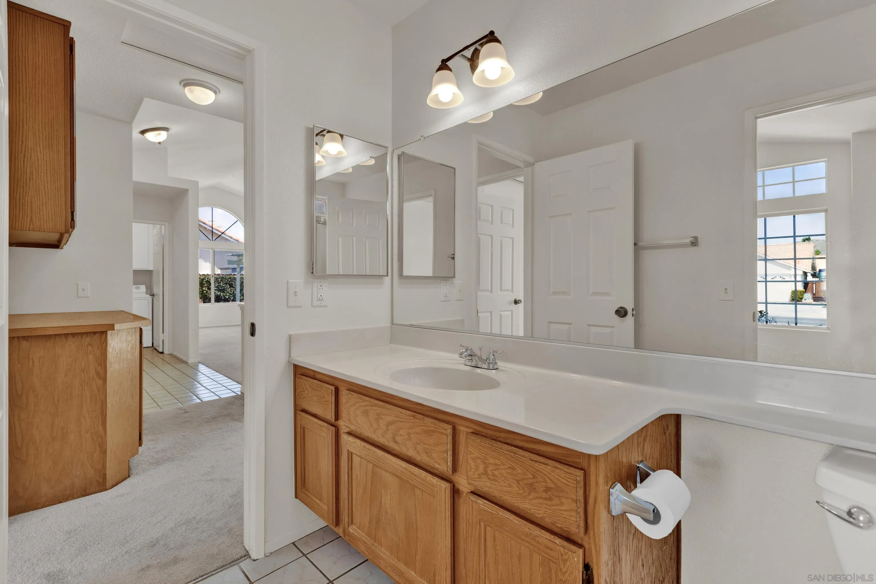 27325 Terrytown Road Menifee, CA 92586 - Photo 31 of 44 a spacious bathroom with a sink a toilet a mirror and shower