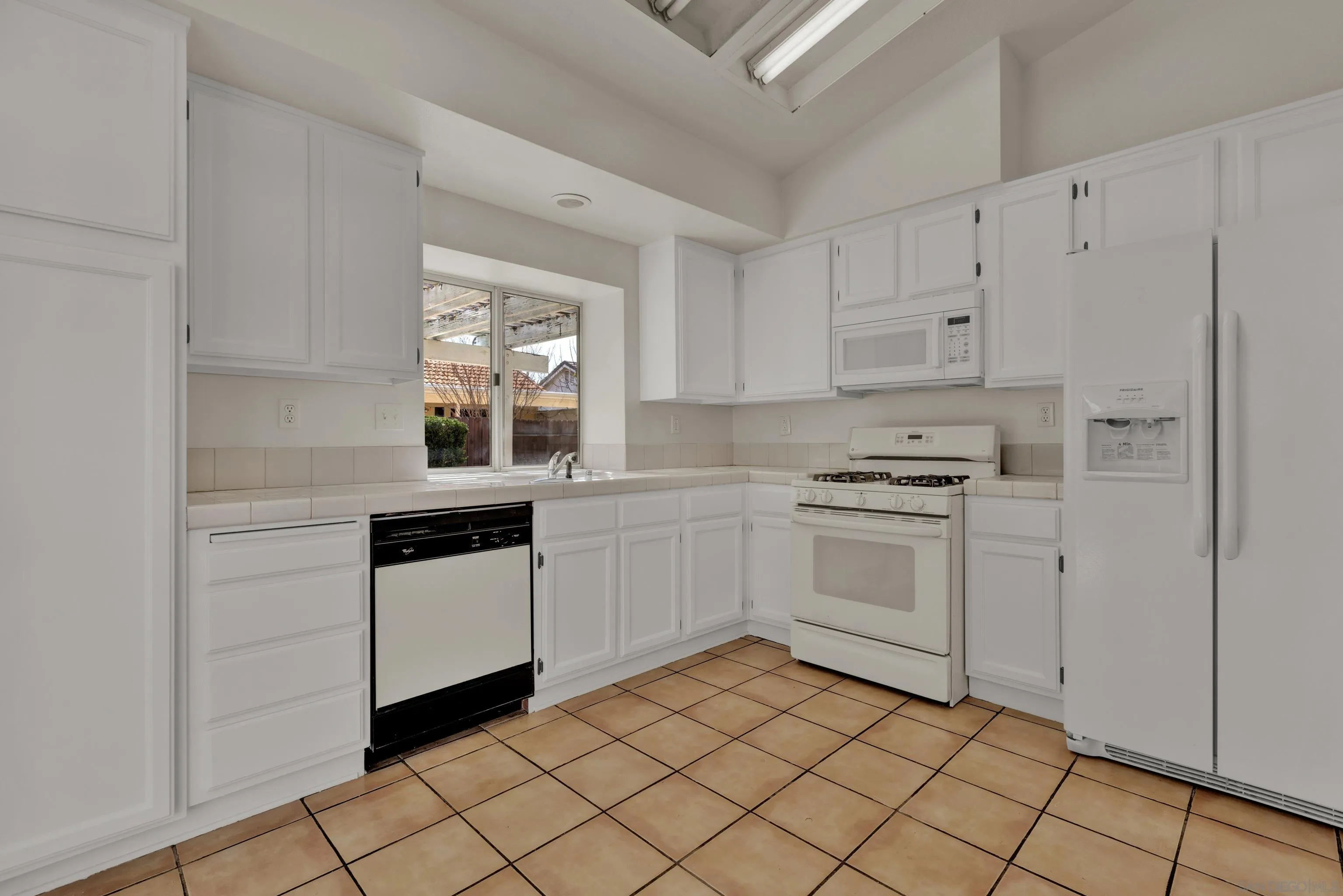 27325 Terrytown Road Menifee, CA 92586 - Photo 8 of 44 a kitchen with white cabinets appliances and a window