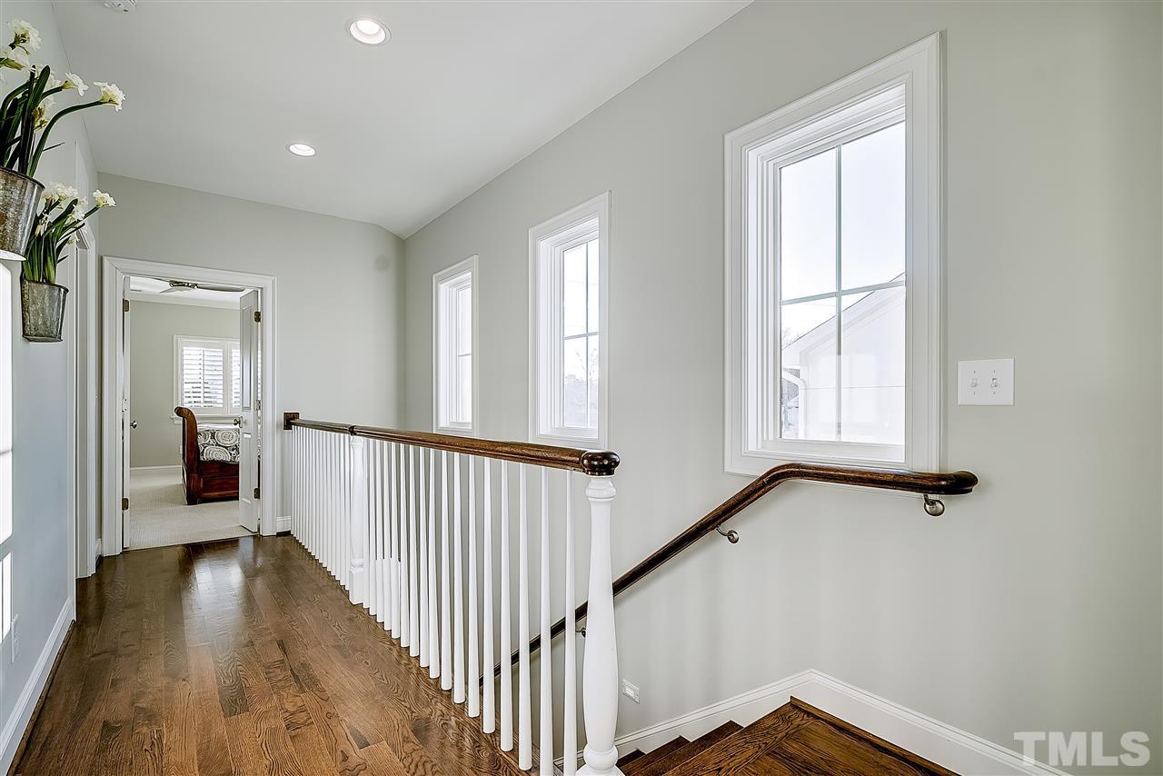 217 Georgetown Road Raleigh, NC 27608 - Photo 19 of 25 a view of a hallway with wooden floor and staircase