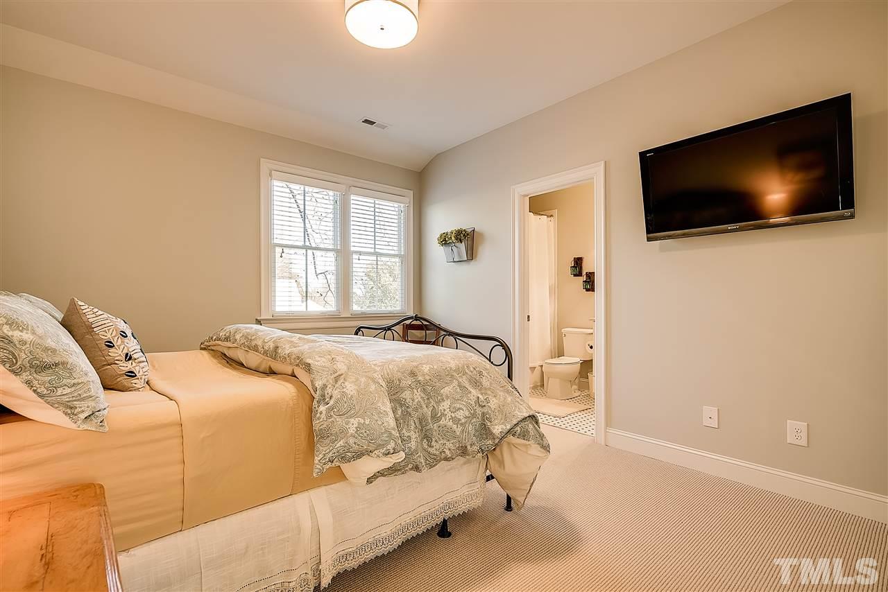 217 Georgetown Road Raleigh, NC 27608 - Photo 21 of 25 a bedroom with a bed and a flat screen tv