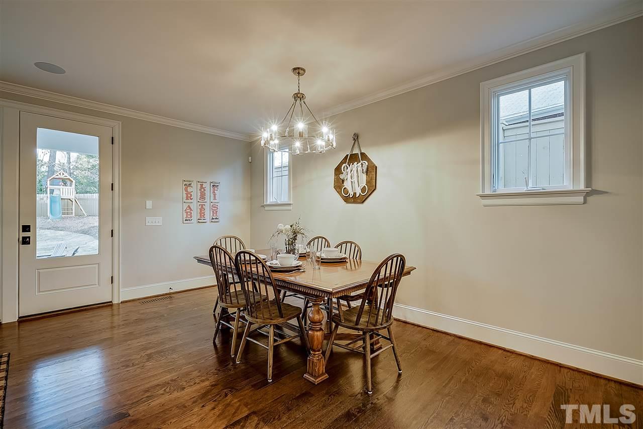 217 Georgetown Road Raleigh, NC 27608 - Photo 22 of 25 a view of a dining room with furniture and wooden floor